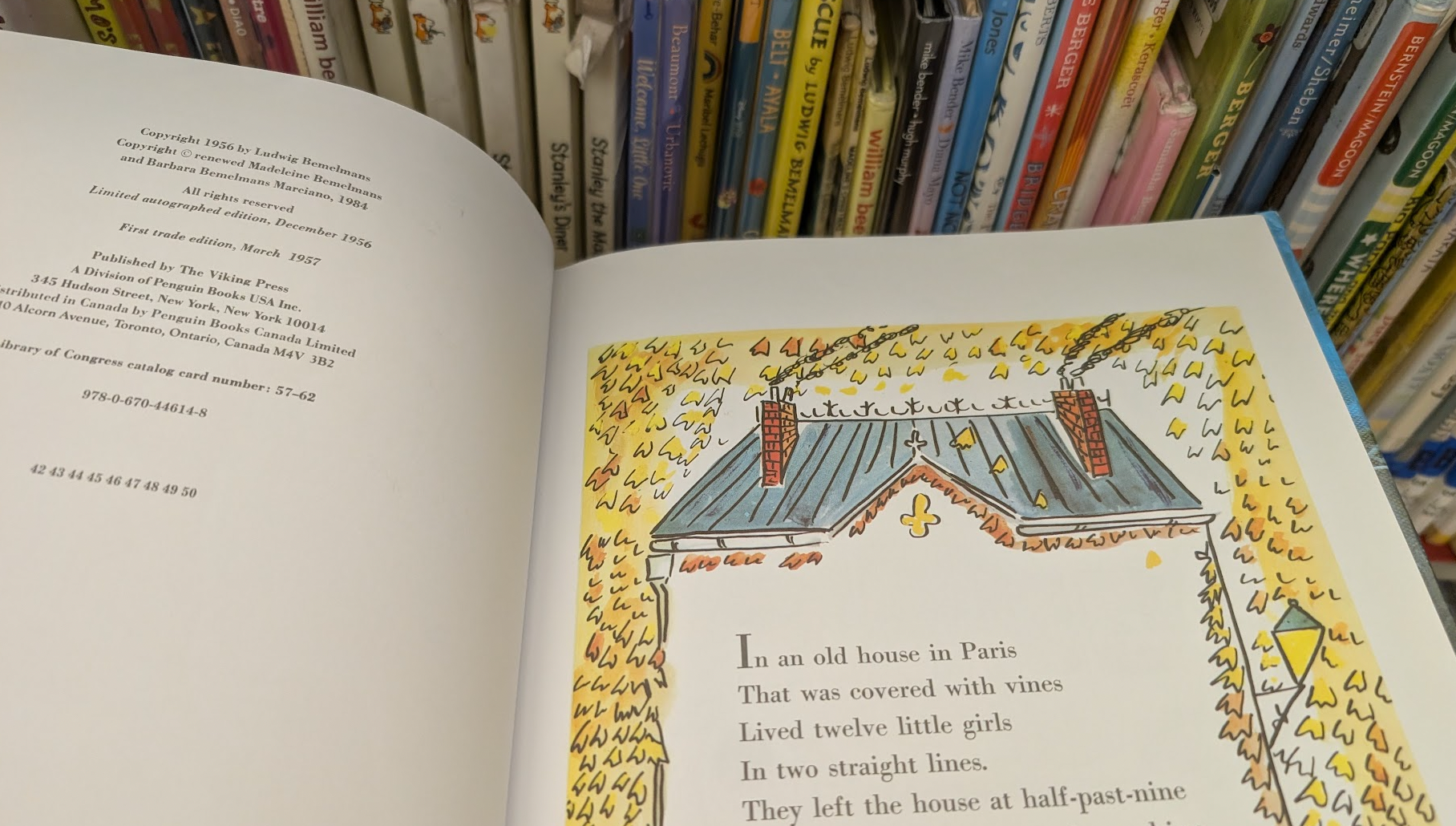 The opening page of Madeline, against a backdrop of children's books.