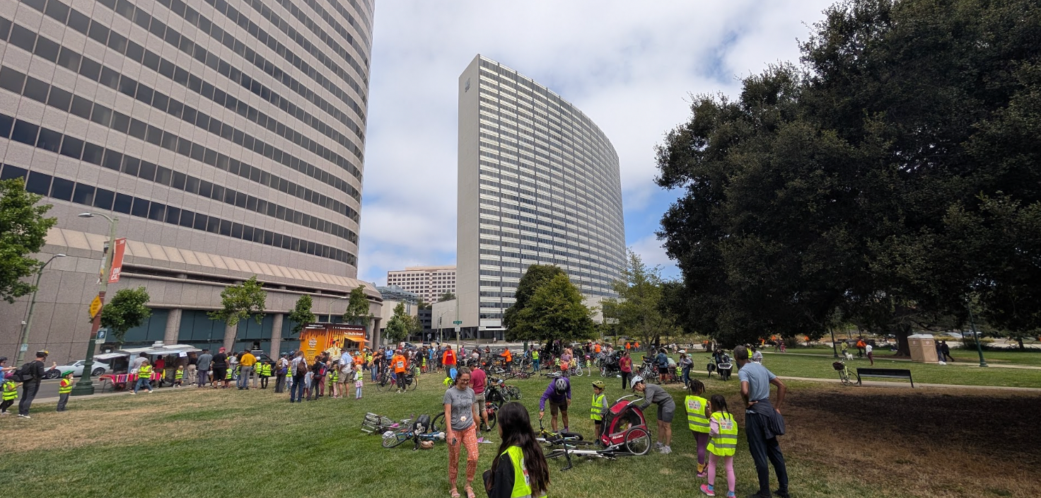 Lounging cyclists after the "kidical mass" bike ride around Lake Merritt.