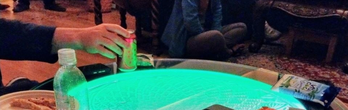 A hand, presumably soft, grasping a craft drink.