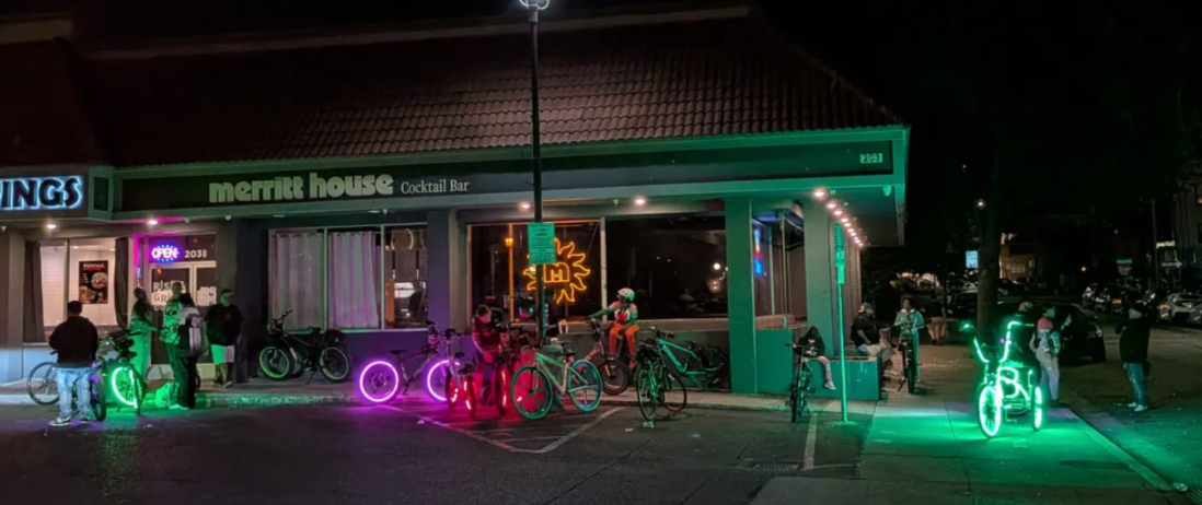 Lit up bicycle wheels, in front of Merritt House cocktail bar.