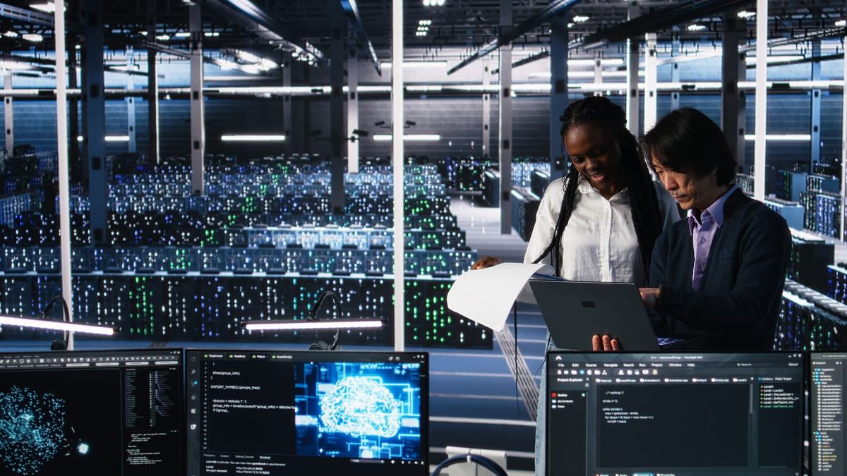 Two staff members are reviewing the updated data center policy. 