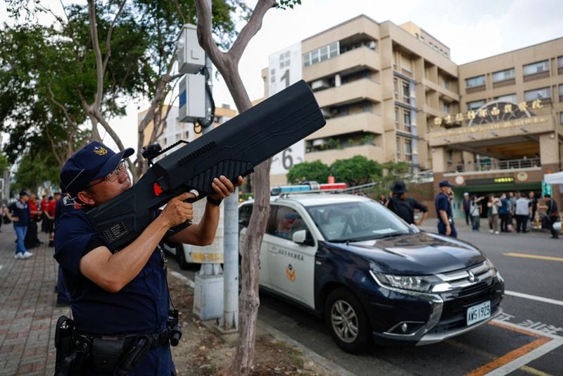 Police officers demonstrate the use of an ADS MK6 counter-drone system outside a hospital during a resilience drill in Nantou
