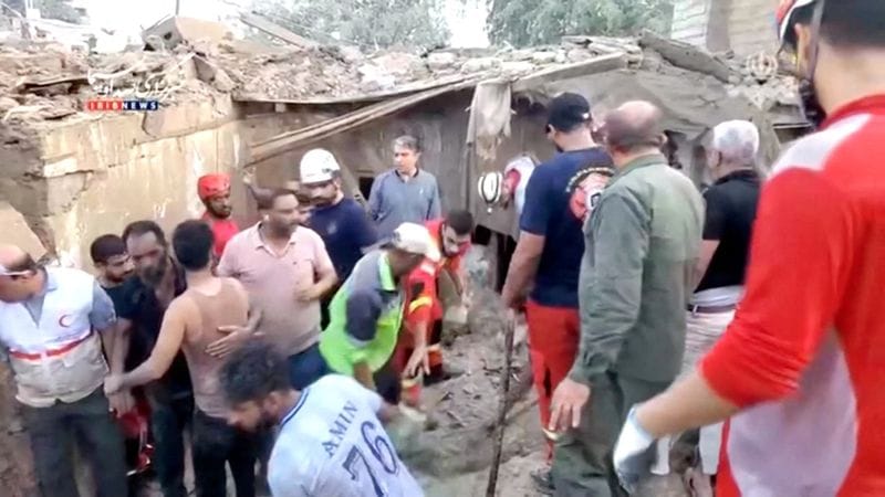 Rescuers clear rubble to search for victims following a strike in Qeshm