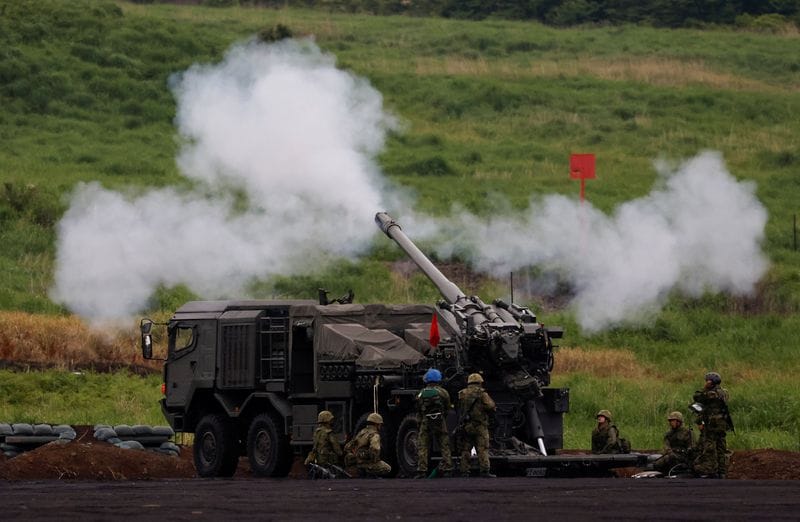 A Japan Ground Self Defense Force's Type 19 155 mm self-propelled howitzer fires during an annual training session near Mount Fuji at Higashifuji training field in Gotemba