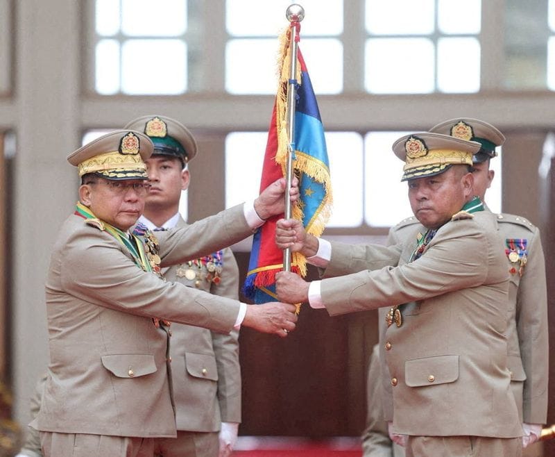 FILE PHOTO: Myanmar junta chief Senior General Min Aung Hlaing hands over a flag to newly appointed Commander-in-Chief General Ye Win Oo during a ceremony in Naypyitaw