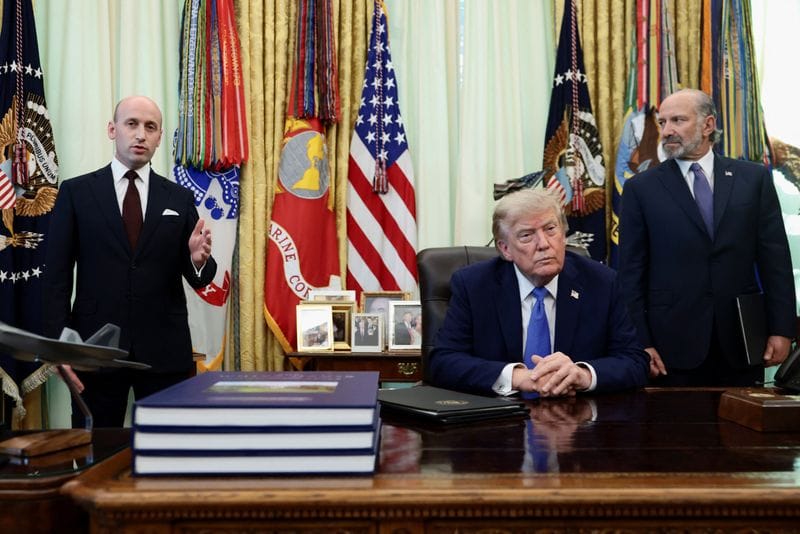 U.S. President Donald Trump signs executive orders at the Oval Office in Washington