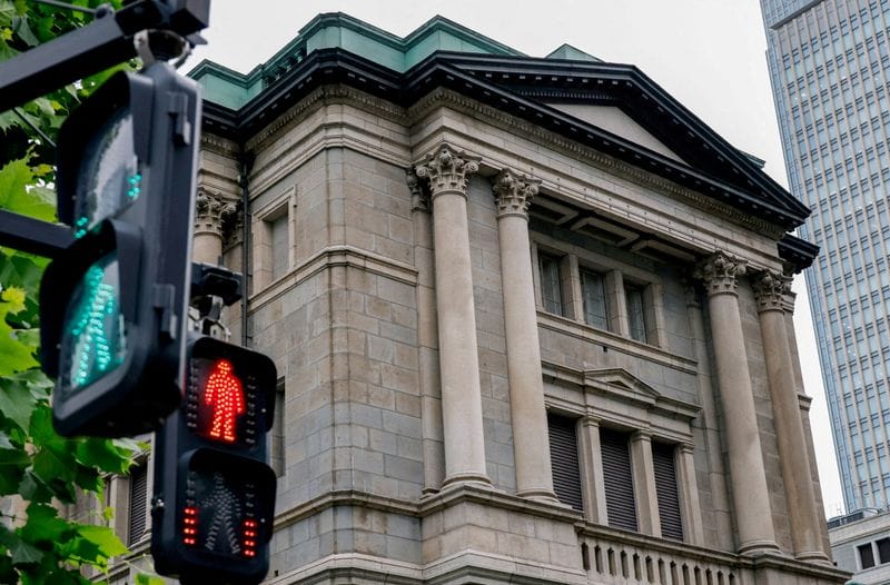 FILE PHOTO: Traffic signs in front of the Bank of Japan building, in Tokyo