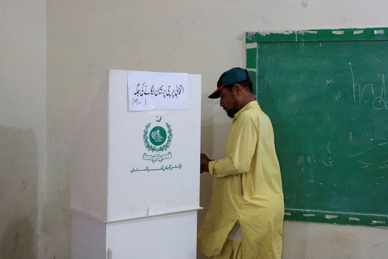 A man votes during the second phase of the Azad Jammu and Kashmir (AJK) Legislative Assembly elections at a polling station in Karachi