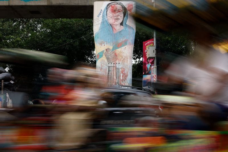 Vehicles move past a mural of Bangladesh's ousted Prime Minister Sheikh Hasina, in Dhaka