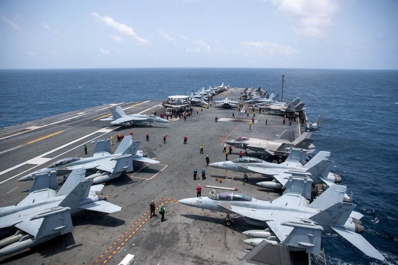 U.S. Navy sailors work on the flight deck of the aircraft carrier USS George Washington as it transits the Arabian Sea