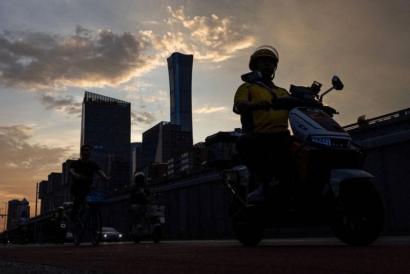 FILE PHOTO: A delivery worker rides a bike, in Beijing