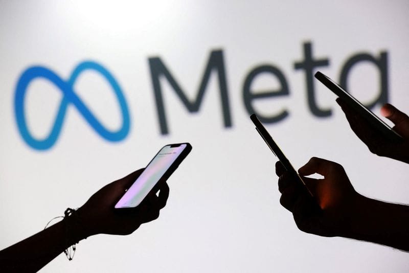 Illustration shows teenagers pose for a photo while holding smartphones in front of a Meta logo
