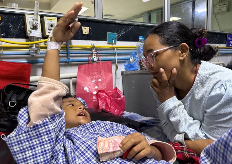 Matti Maya Tamang meets with her son Zoyal Ghale two days after devastating floods in Nepal