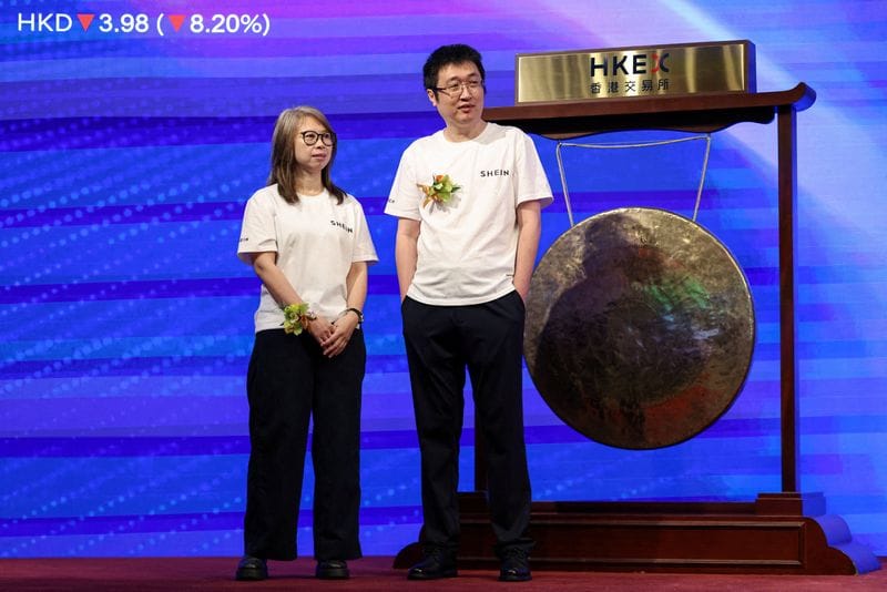 Founder and chairman of online retailer Shein Xu Yangtian, also known as Sky Xu or Chris Xu, and Financial Director Poppy Bao attend the company's listing ceremony at the Hong Kong Stock