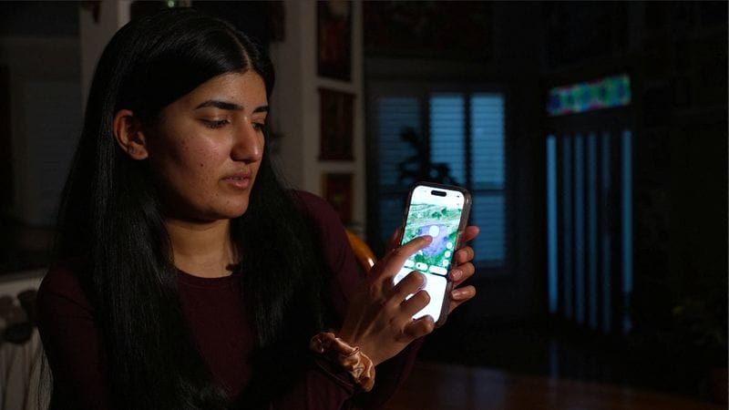 Australian medical student, Sarada Viswanathan, looks at a screenshot of her partner's last known location in Nepal on app Life360, in Sydney