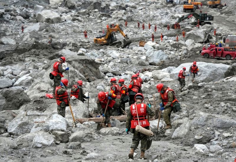 Rescue workers conduct search and rescue operations following mudslide at Gyirong Port