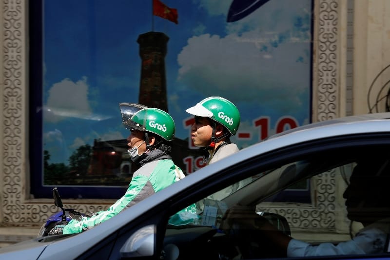 A Grab mototaxi drives on a street in Hanoi