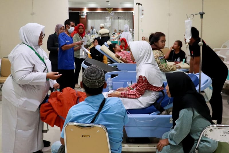 Students rest while receiving treatment for food poisoning at the regional general hospital after eating government-sponsored free school meals in Pati