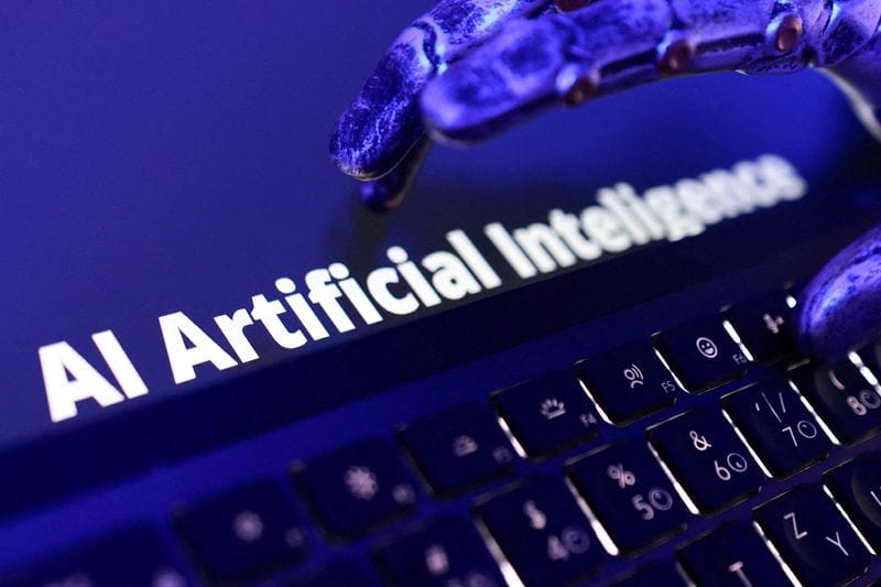 FILE PHOTO: Illustration shows words "AI Artificial Inteligence", keyboard and a robotic hand