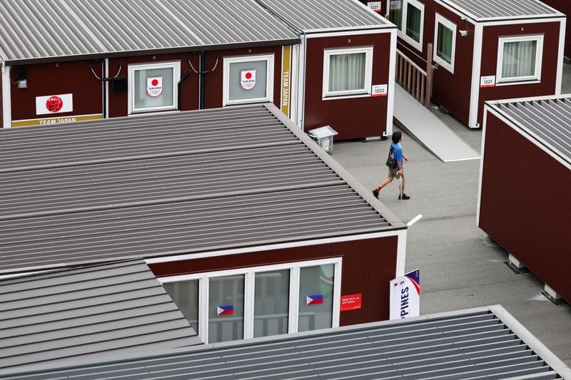 People walk near wooden container units built to house athletes, ahead of the Aichi-Nagoya 2026 Asian Games, in Nagoya