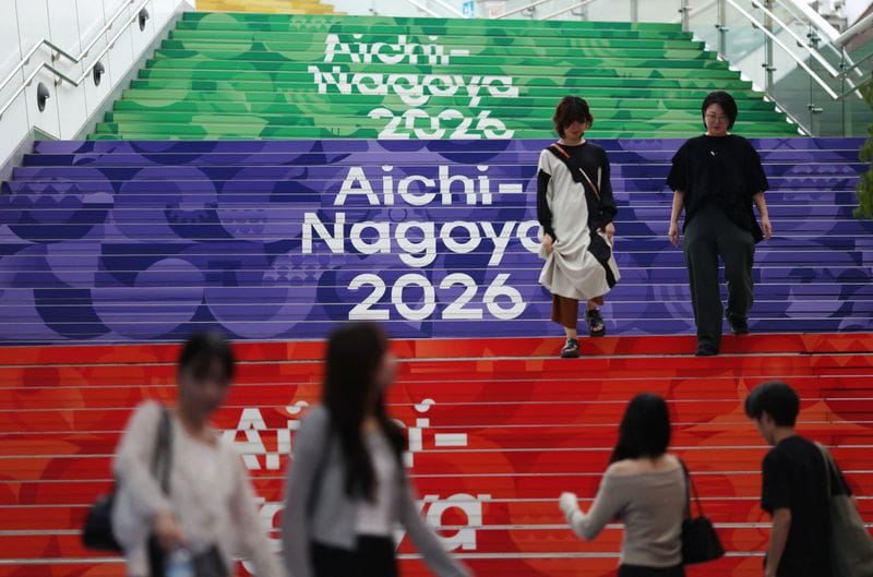 People walk past Asian Games signages in Nagoya