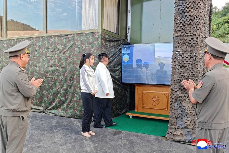 North Korean leader Kim Jong Un, accompanied by his daughter Kim Ju Ae, attends a test of a new type of weapon at an undisclosed location