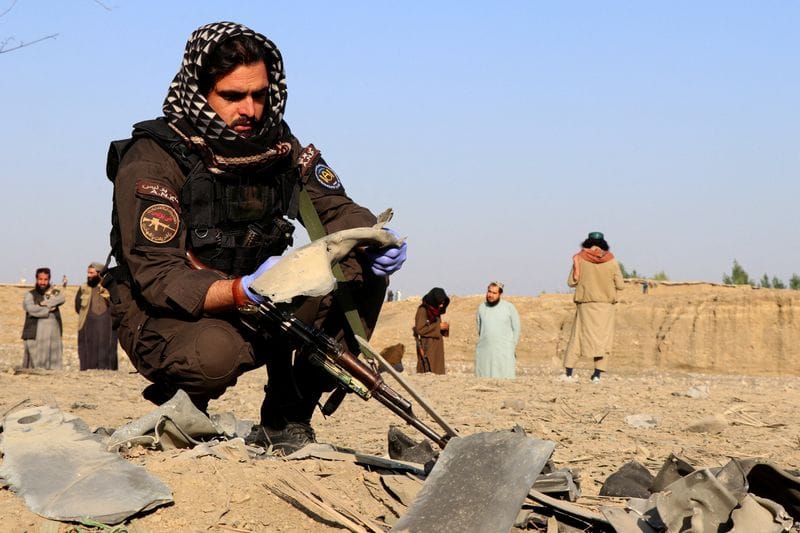 FILE PHOTO: A member of the Taliban security forces inspects metal debris at the site of a partially damaged house, in Gurbuz