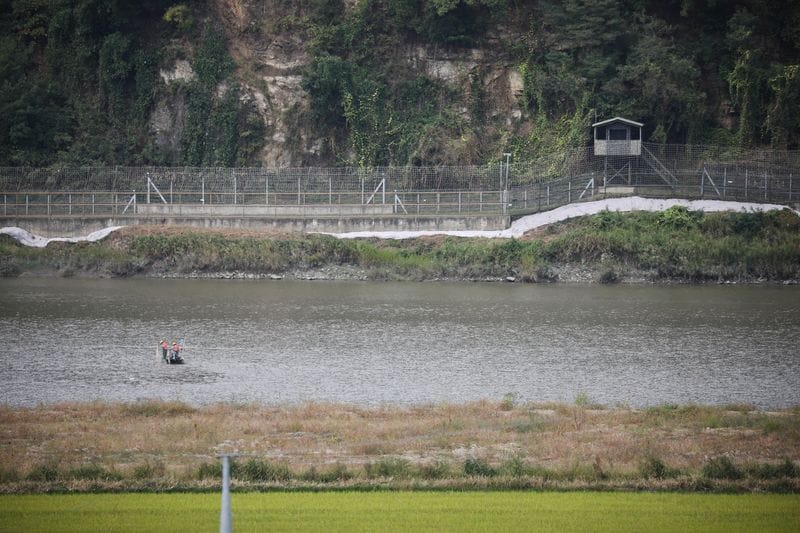 Fishermen work in front of a South Korea's observation post near the demilitarized zone separating the two Koreas in Paju