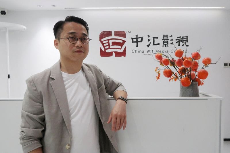 Zhu Zhili, a Chinese AI director, poses for photos in Shenzhen