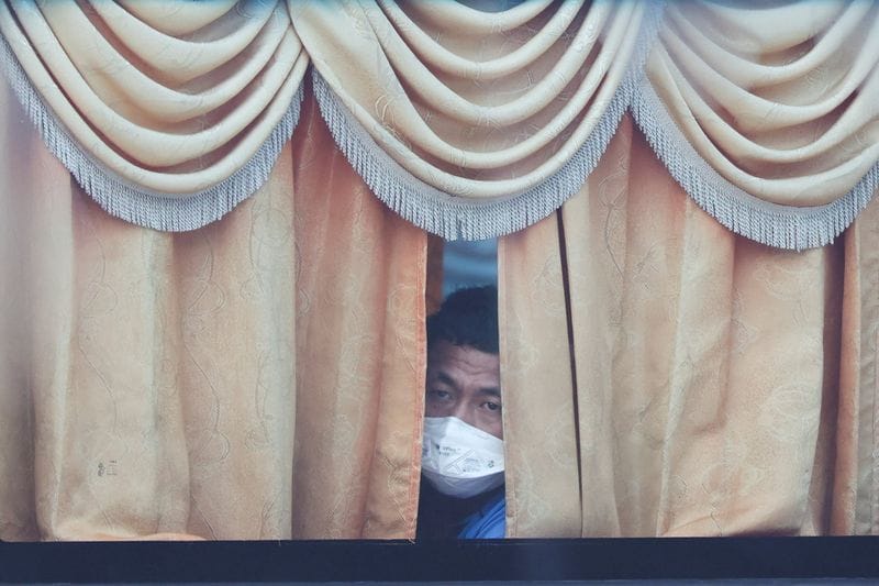 Myanmar migrants to be repatriated from Malaysia sit inside a bus, at Lumut