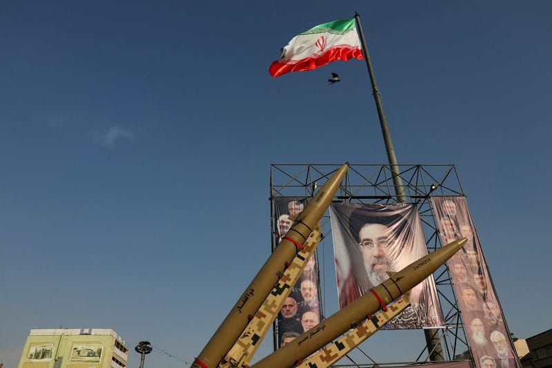 Iranian missiles are displayed next to a banner with a picture of Iran's Supreme Leader, Mojtaba Khamenei, on a street in Tehran