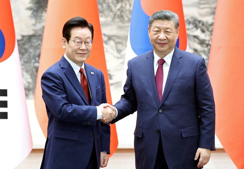 FILE PHOTO: Chinese President Xi Jinping and South Korean President Lee Jae Myung in Beijing