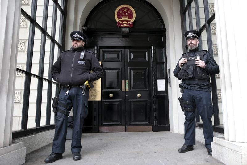 Policemen stand guard outside the Chinese Embassy in London, Britain