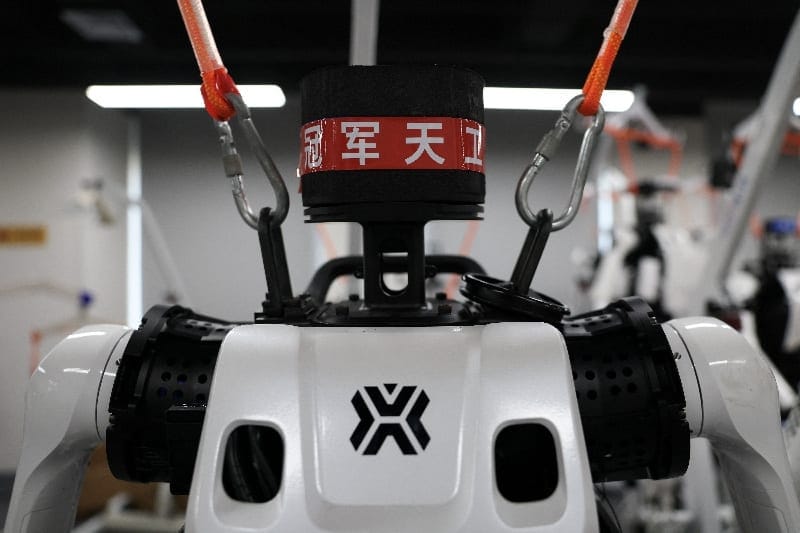 A "champion" label is displayed on a Tiangong Ultra humanoid robot suspended from a mobile crane in the research and testing area of the Beijing Humanoid Robot Innovation Center, also known as X-Humanoid, in Beijing, China, September 4, 2026. REUTERS