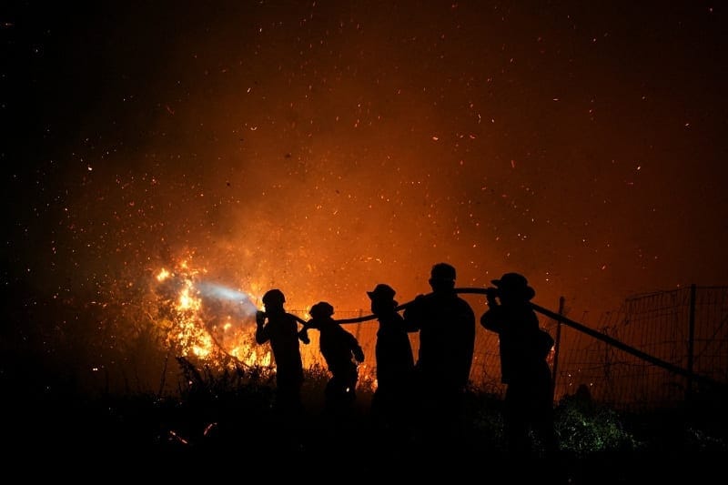 Firefighters spray water in an attempt to extinguish a wildfire in Palembang, South Sumatra province, Indonesia, September 8, 2026. REUTERS/Abriansyah Liberto