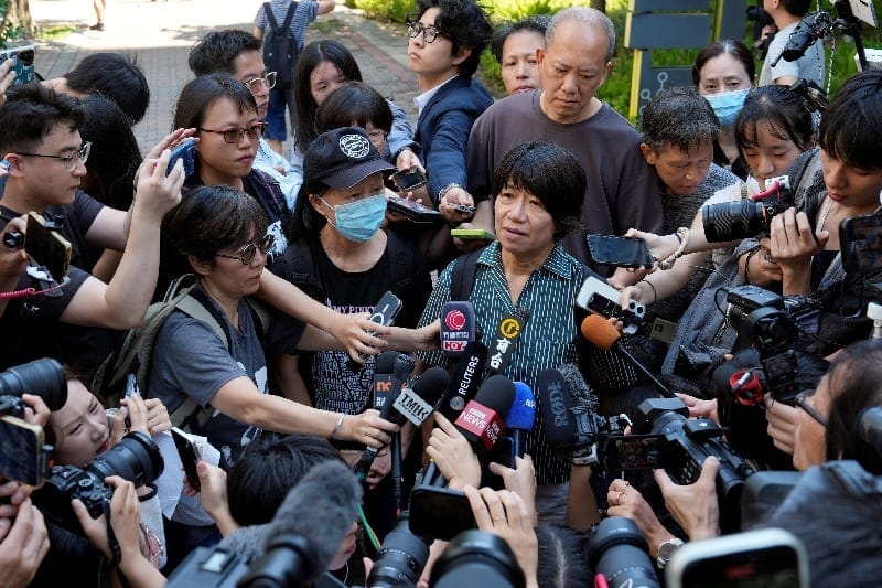 Journalists surround Medina Chow Lau Wah-chun, mother of Chow Hang-tung, and Elizabeth Tang Yin-ngor, wife of Lee Cheuk-yan, outside West Kowloon Law Courts Building, where former leaders of the disbanded Hong Kong Alliance in Support of Patriotic De