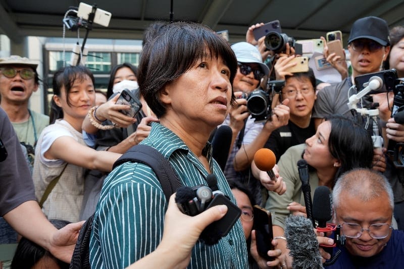Journalists surround Elizabeth Tang Yin-ngor, wife of Lee Cheuk-yan, outside West Kowloon Law Courts Building, where former leaders of the disbanded Hong Kong Alliance in Support of Patriotic Democratic Movements of China, which organised annual Tian