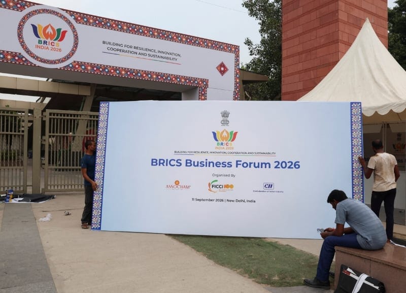 People carry a BRICS Business Forum 2026 billboard to place outside Bharat Mandapam, the venue of the upcoming 18th BRICS Summit in New Delhi, India, September 11, 2026. REUTERS/Sahiba Chawdhary