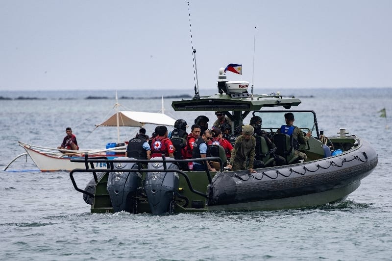 Authorities and responders board a vessel to assist ongoing search and rescue operations involving the MV June Aster ferry, which caught fire off the coast of Palawan, Philippines, September 11, 2026. REUTERS/Eloisa Lopez