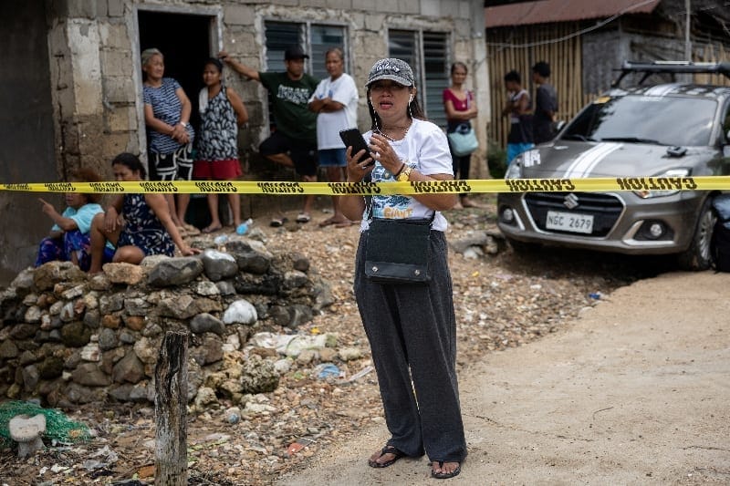 Janelle Navawa, 48, cries while speaking to a relative on the phone as she waits for information about family members who are among those missing following a fire aboard the MV June Aster ferry off the coast of Palawan, in Coron, Philippines, Septemb