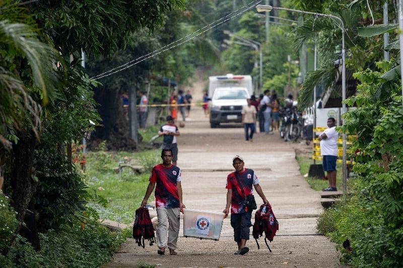 Representatives from the Philippine Red Cross carry equipment to assist ongoing search and rescue operations involving the MV June Aster ferry, which caught fire off the coast of Palawan, in Coron, Philippines, September 11, 2026. REUTERS/Eloisa Lope