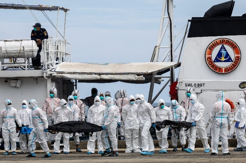 Members of the Philippine Coast Guard carry body bags containing the recovered remains of victims of a fire aboard the MV June Aster ferry off the coast of Palawan, in Coron, Philippines, September 13, 2026. REUTERS/Eloisa Lopez