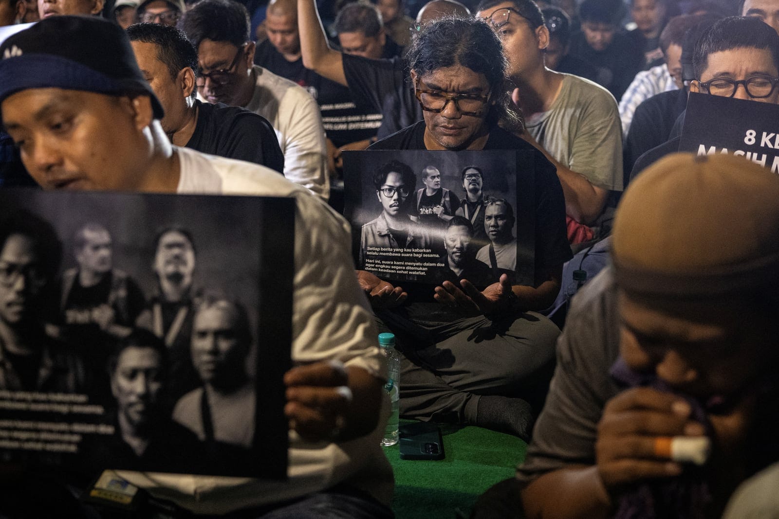 Members of Indonesian photojournalist association hold the pictures of their fellow journalists who went missing while covering the eruption of Mount Anak Krakatau volcano, during a prayer vigil in Jakarta, Indonesia, September 11, 2026. REUTERS/Will