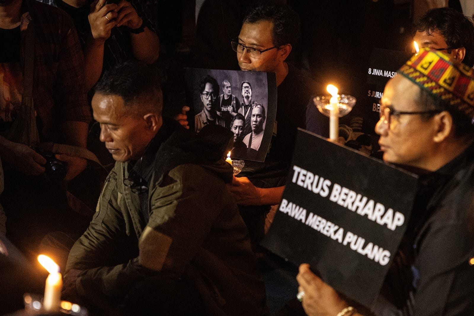 Members of Indonesian photojournalist associations hold candles and the picture of their fellow journalists who went missing while covering the eruption of Mount Anak Krakatau volcano, during a prayer vigil in Jakarta, Indonesia, September 11, 2026.