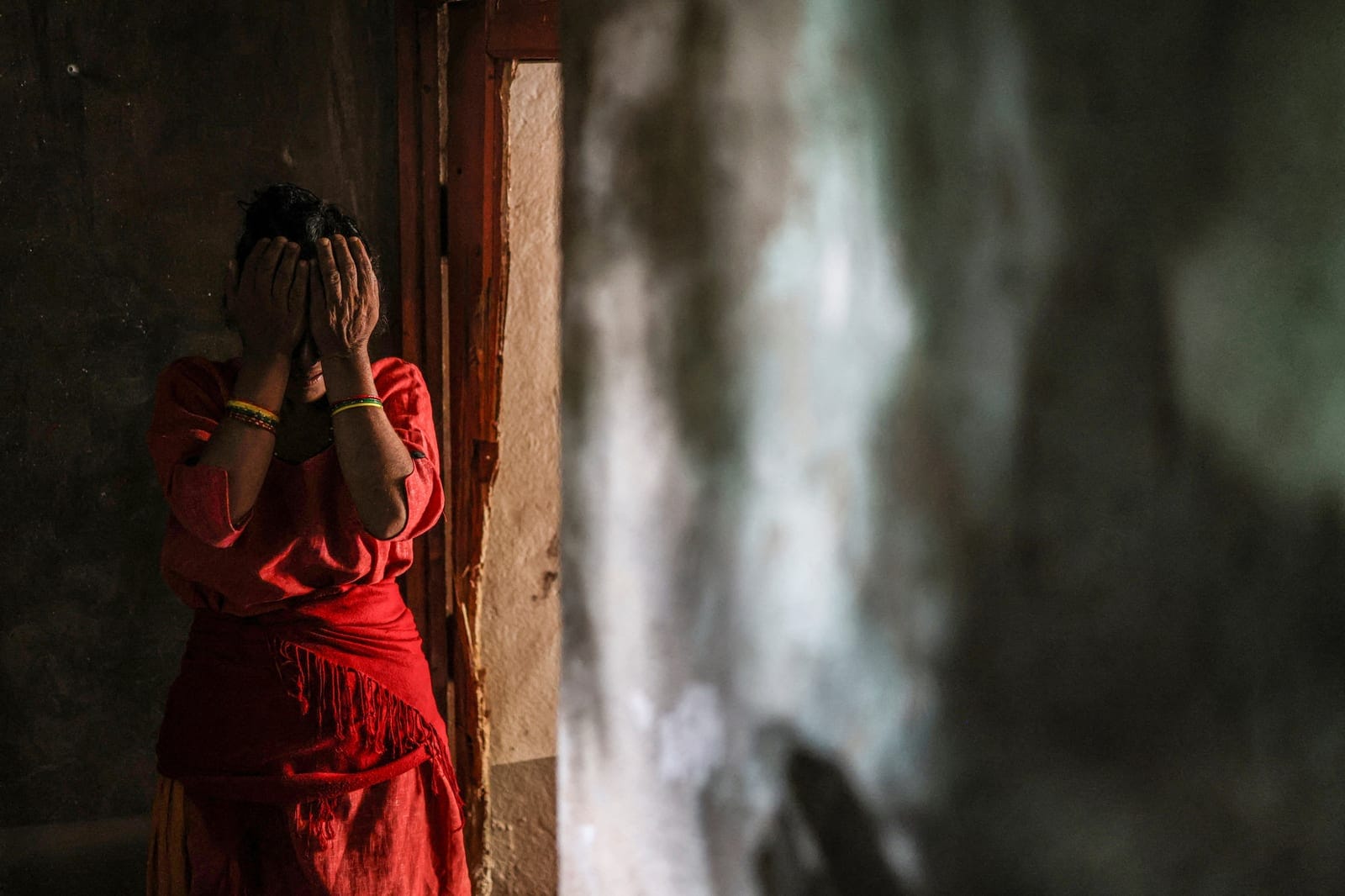 Shanti Pudasaini, 53, cries inside her house as she speaks about her uncertain future following flash floods and mudslides in Devighat, Nuwakot district, Nepal, September 9, 2026. In Devighat, residents have been salvaging what belongings they can, t