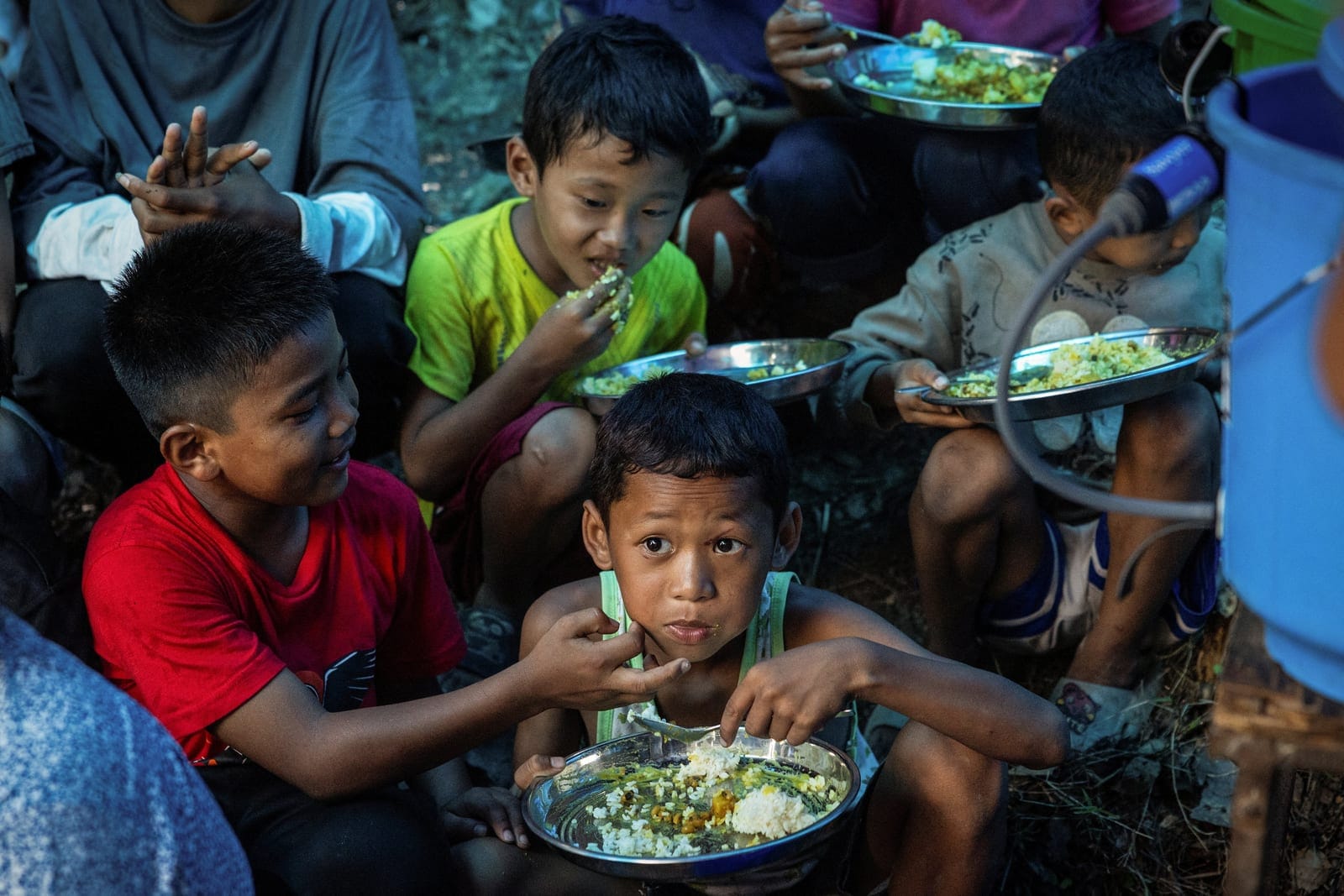 Children displaced by flash floods and mudslides eat lunch inside a makeshift kitchen at a temporary shelter on a hill in Betrawati, Nuwakot district, Nepal, September 9, 2026. Each day, scores of survivors sheltering in clusters of tents on a hillsi