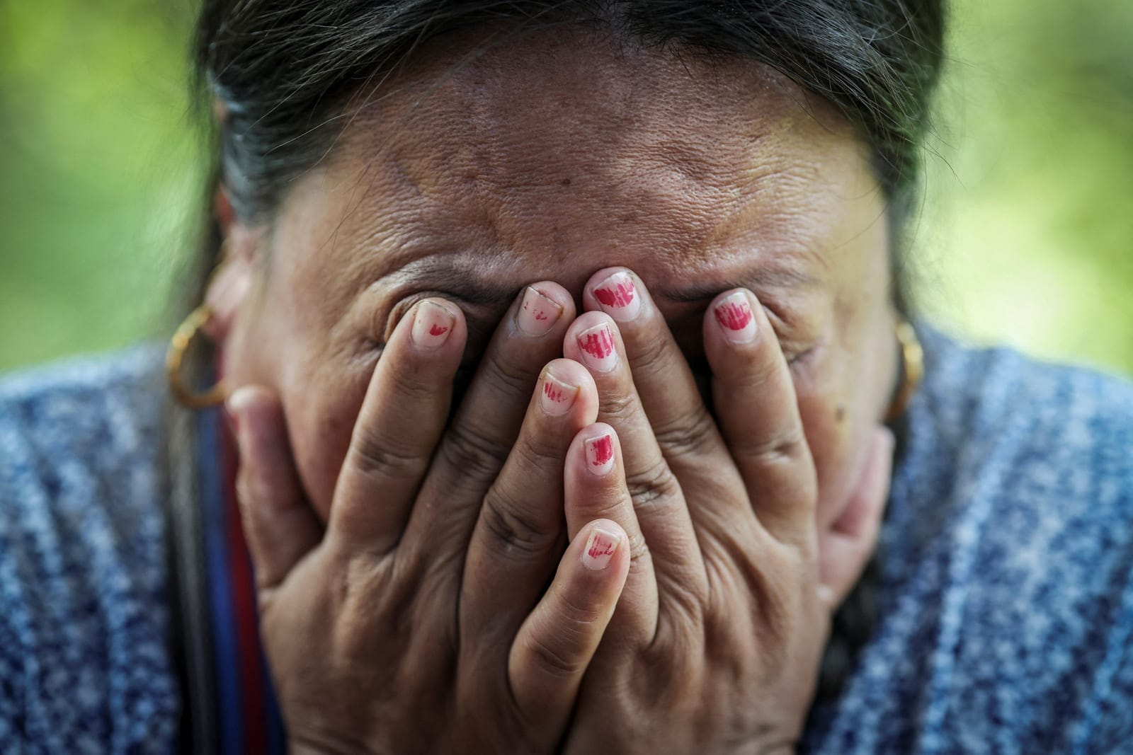 Kalpana Thapa Magar, 43, displaced by flash floods and mudslides, cries while sitting outside her tent at a temporary shelter on a hill in Betrawati, Nuwakot district, Nepal, September 9, 2026. Betrawati residents said warnings about the approaching 