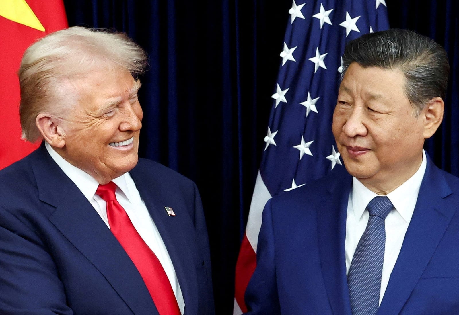 FILE PHOTO: U.S. President Donald Trump and Chinese President Xi Jinping react as they hold a bilateral meeting at Gimhae International Airport, on the sidelines of the Asia-Pacific Economic Cooperation (APEC) summit, in Busan, South Korea, October 3