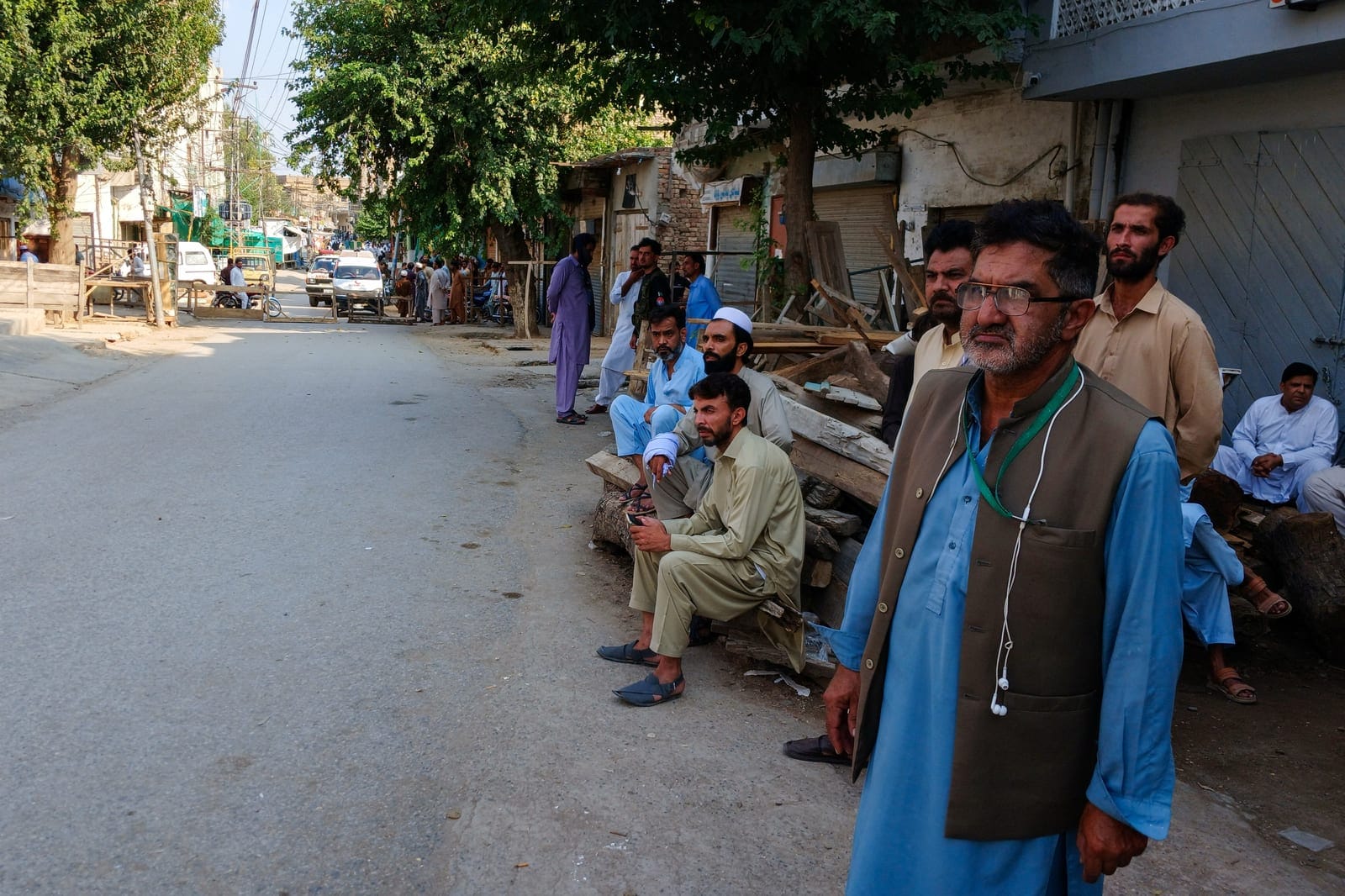 Residents gather on a street leading to a police facility, where ambulances are parked following a suicide attack in Kohat, Pakistan, September 18, 2026. REUTERS/Stringer
