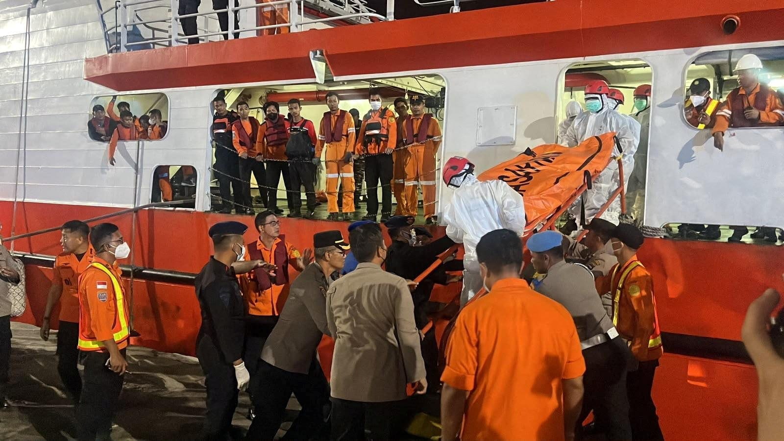 Rescue members wearing personal protective equipment carry a body bag as they retrieve victims of the Virgo Transport 8 ferry, which capsized in the Java Sea while sailing from Surabaya to Banjarmasin, upon arrival at Trisakti Port in Banjarmasin, So